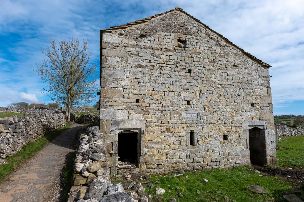 Historic stone barn on a cobbled path in the Yorkshire Dales