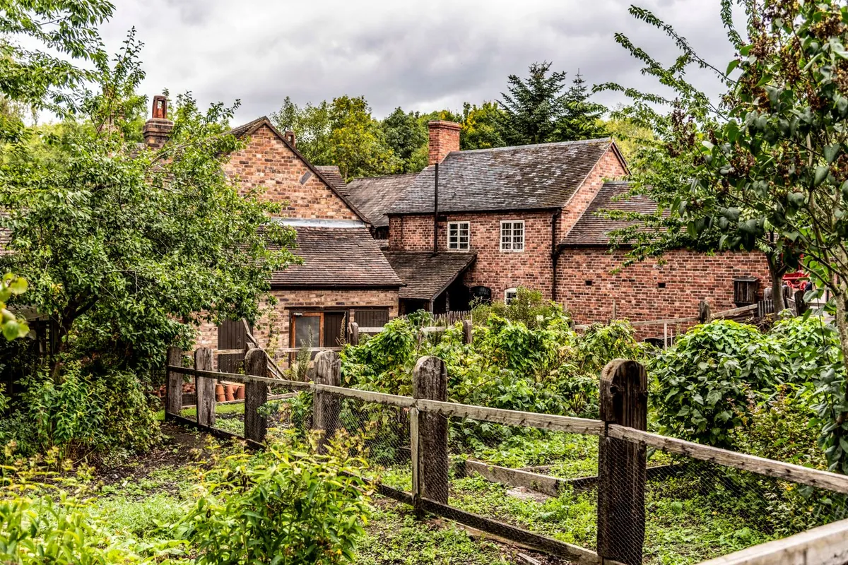 English brick house with a garden and timber fencing