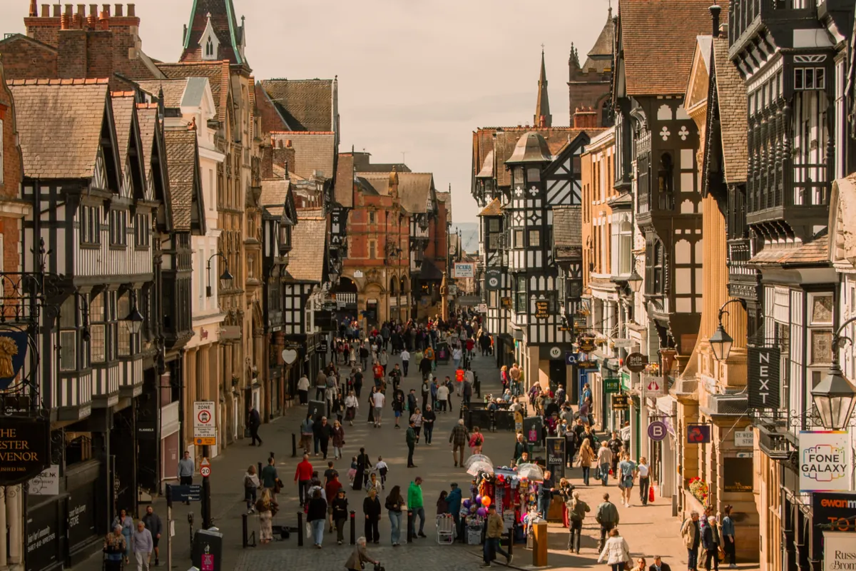 Shops and businesses on a bustling historic high street in Chester