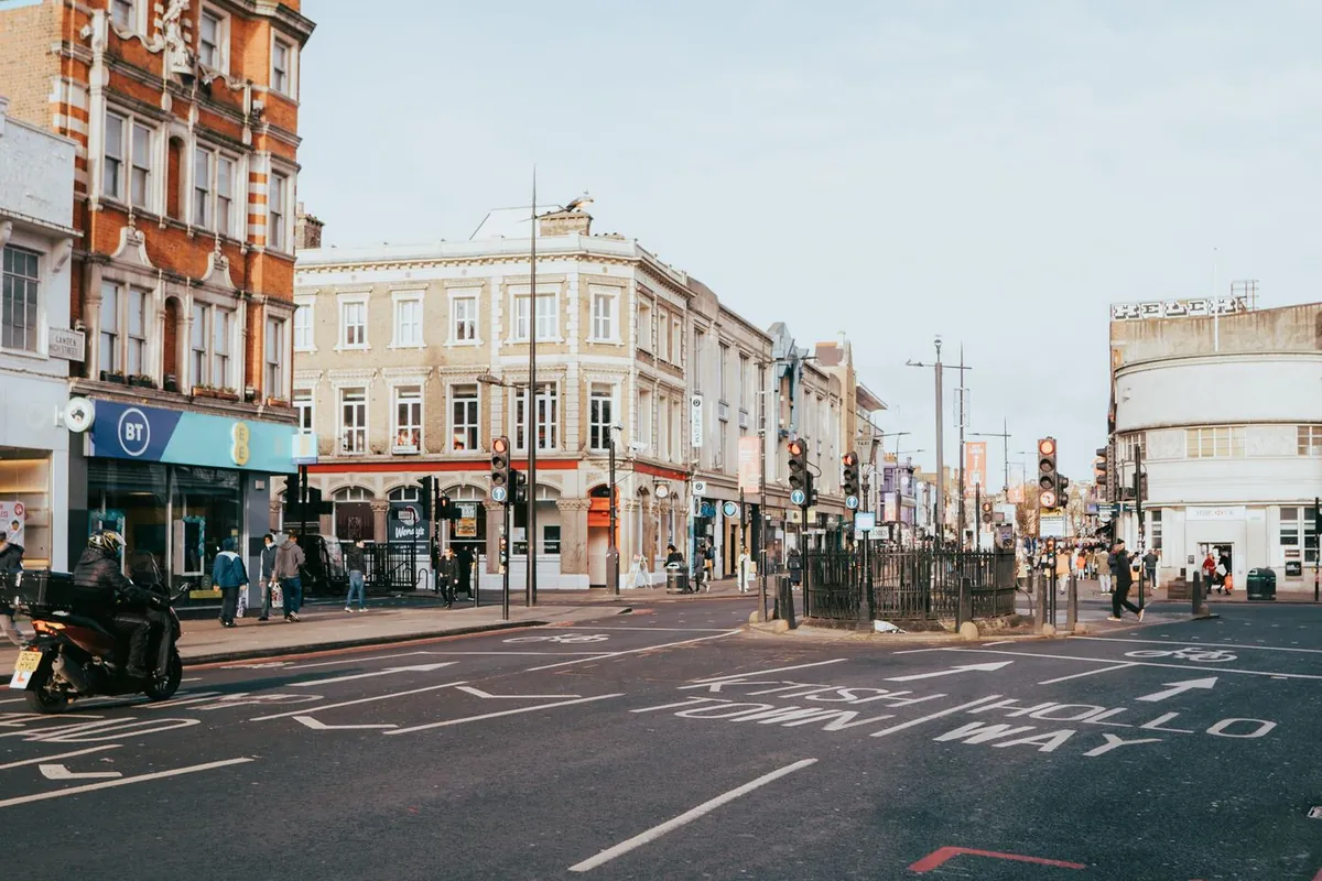 A London high street with shops and traffic